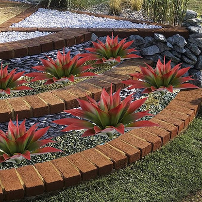 Cluster of wine-red faux agave plants with green centers in white planters