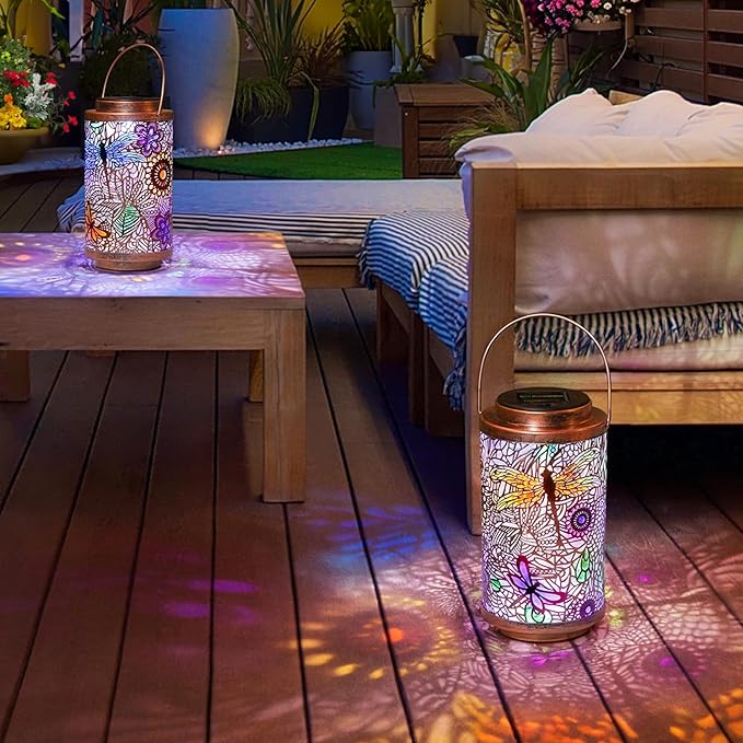 Solar dragonfly lantern on wooden deck, multicolor glass pattern and copper top with handle