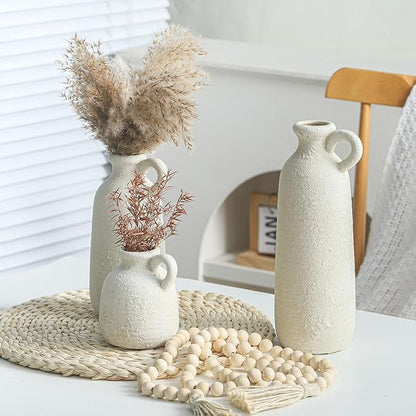 Set of 3 white ceramic vases with loop handles, textured surface with shorter center vase