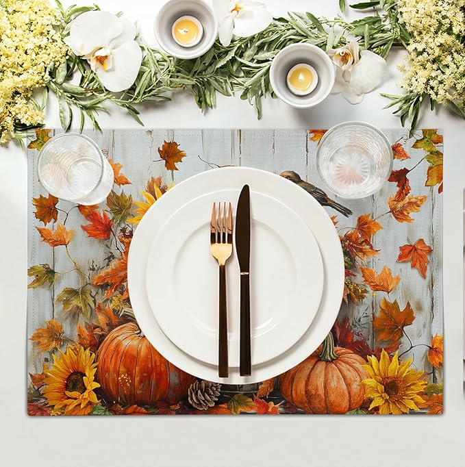 Cotton-linen placemat with pumpkins and sunflowers under a white plate and cutlery set