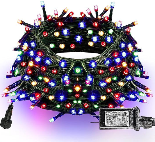 Multicolor LED Christmas string lights on green wire, close-up bulb cluster