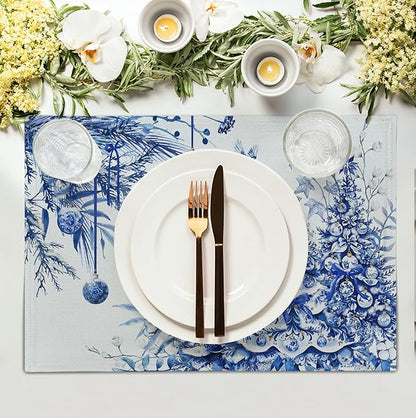 Blue-and-white Christmas tree placemat under a white plate and cutlery