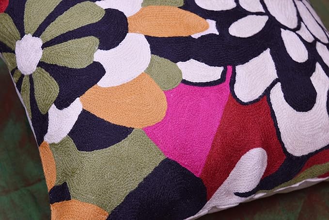 Embroidered floral pillow cover with black outlines, white petals, and magenta accents