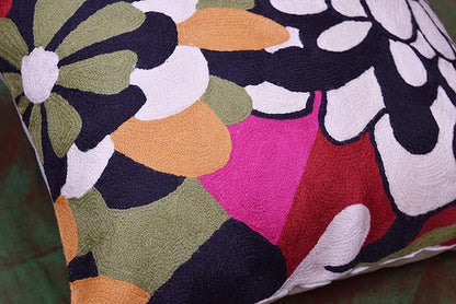 Embroidered floral pillow cover with black outlines, white petals, and magenta accents