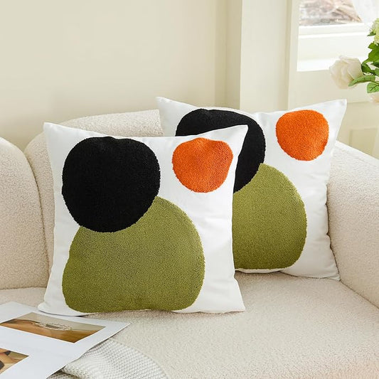 Boho tufted pillow cover with white base and large black, olive-green, orange dot shapes
