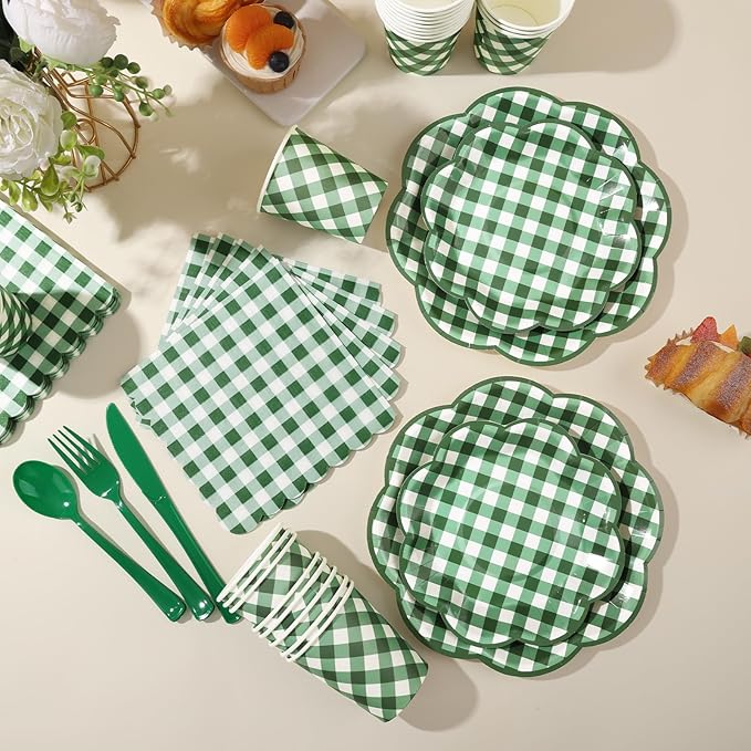 Green-and-white gingham picnic tableware set with plates, napkins, and utensils laid out