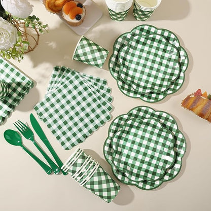 Green-and-white gingham picnic tableware set with plates, napkins, and utensils laid out