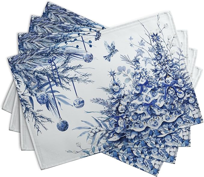 Four blue-and-white rectangular Christmas placemats fanned out with floral tree pattern