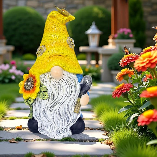 Solar LED gnome yard statue in yellow hat with white beard and sunflower, outdoor setting