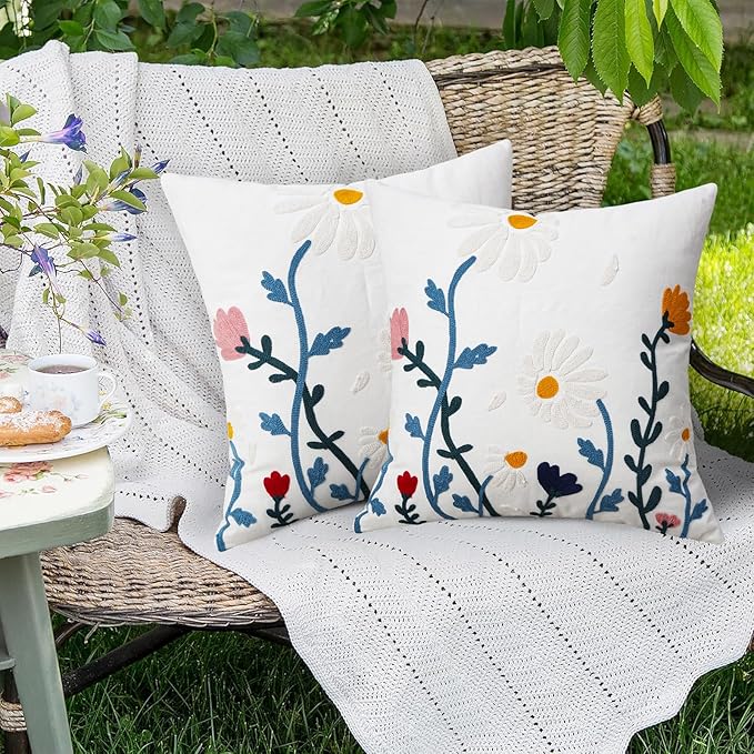 White square pillow cover with blue floral vine embroidery and multicolor flower details