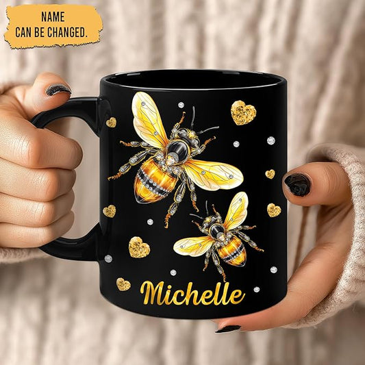 Black ceramic mug held in hands, bee graphic and gold hearts, personalized Michelle