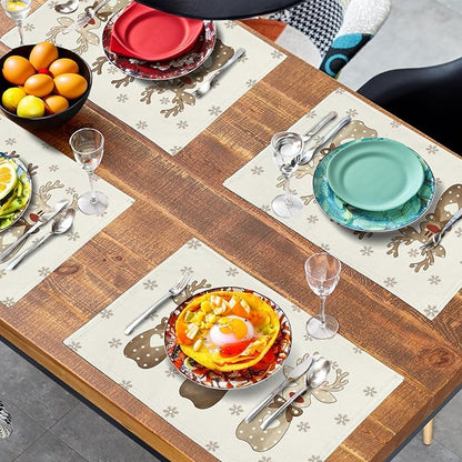 Reindeer snowflake placemats on table with dinner plates, cutlery, and drinks