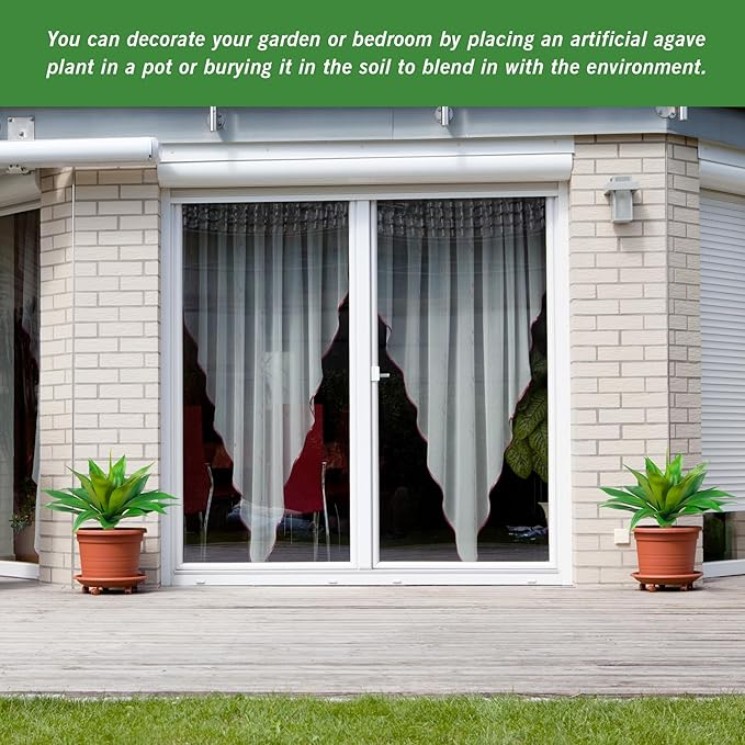 Two green faux agave plants in terracotta pots in front of a house door