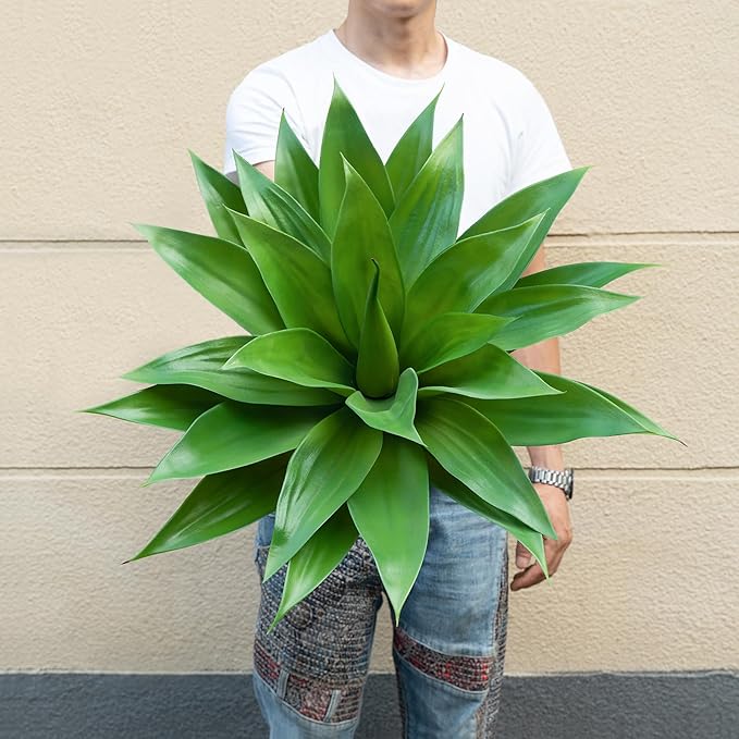 Large artificial green agave plant with spiky leaves and beige pot