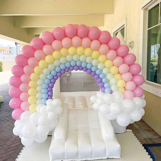 Rainbow balloon arch with pink, yellow, blue, and white balloons surrounding an inflatable frame