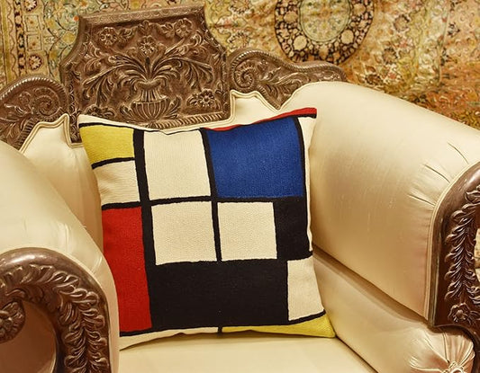 Geometric pillow cover with red, blue, yellow, white, and black square pattern