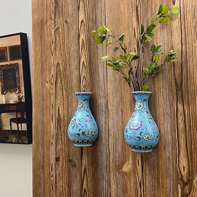 Set of two blue and white porcelain wall vases on a wooden plank wall