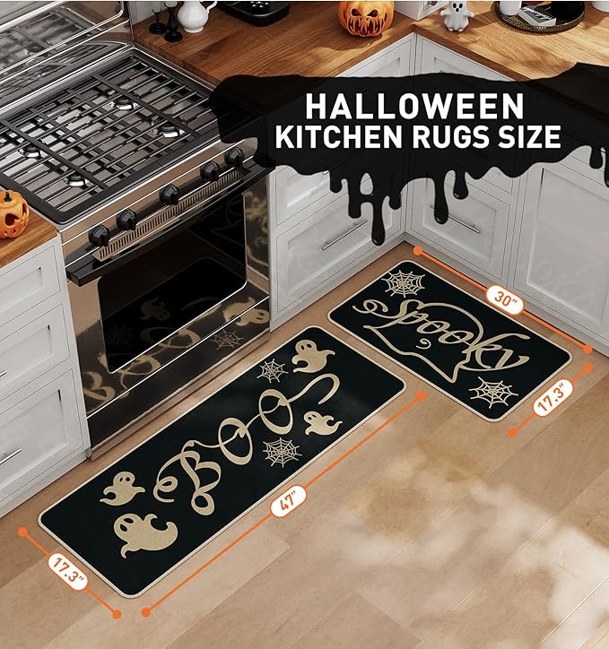 Two black Halloween kitchen rugs with gold ghost and spider web patterns