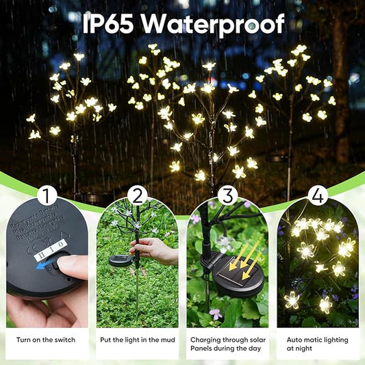Solar garden light set, glowing warm white LED flower branches on stake with round solar base