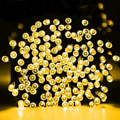 Close-up of warm white LED bulbs on a fairy string, glowing yellow