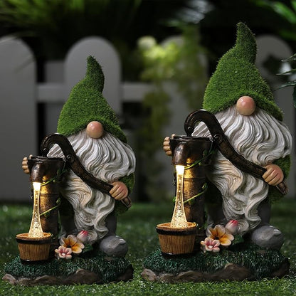 Pair of solar-powered resin garden gnomes with green caps, white beards, and glowing lanterns
