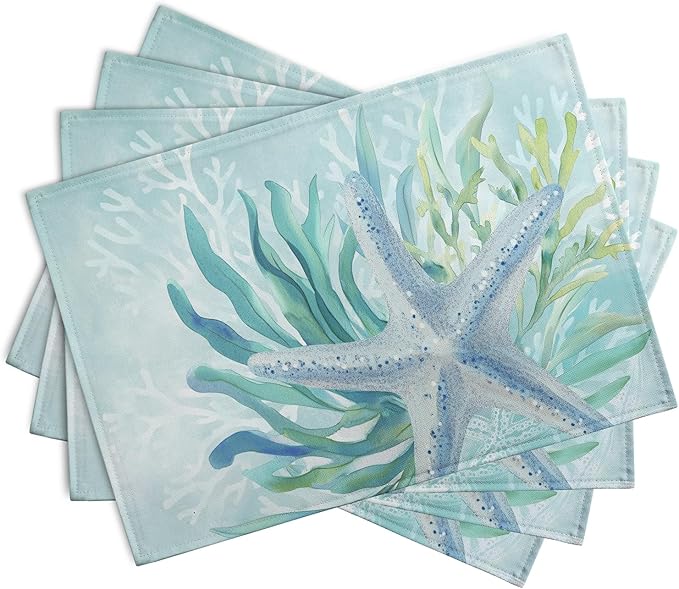 Set of teal blue ocean placemats with starfish and seaweed print, shown stacked