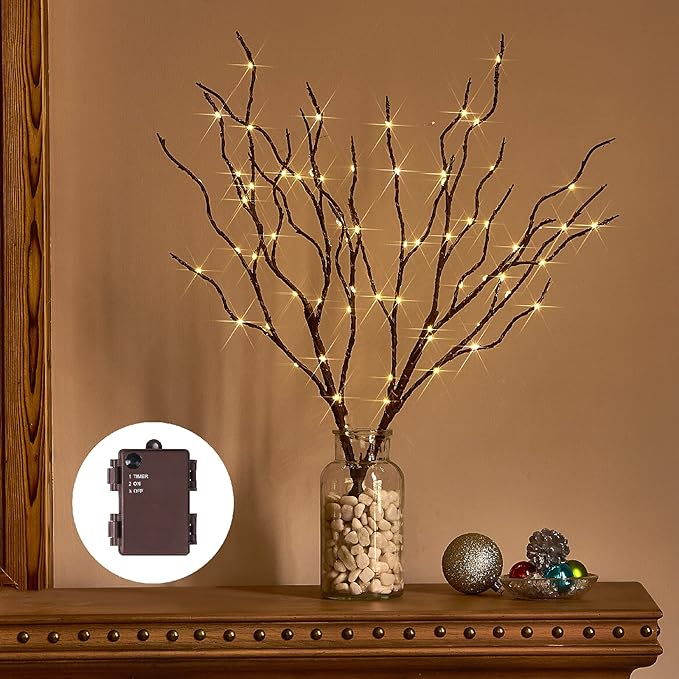Brown lighted willow branches in vase with warm white string lights, timer box nearby