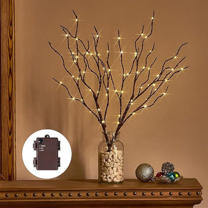 Brown lighted willow branches in vase with warm white string lights, timer box nearby