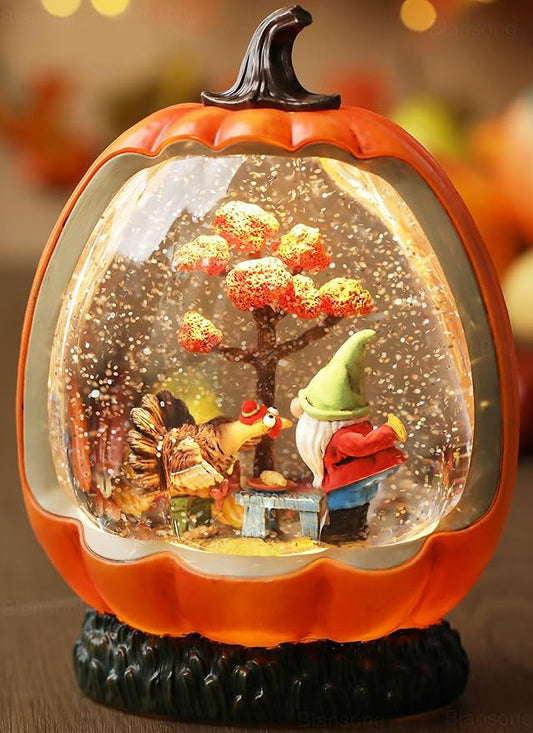 Orange pumpkin snow globe with swirling glitter and small fall character scene inside dome