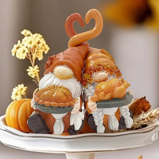 Resin fall gnome figurines with turkey and pumpkin pie on a white platter