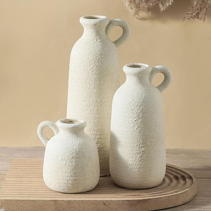 Set of 3 white ceramic vases with loop handles, three textured shapes on a round tray