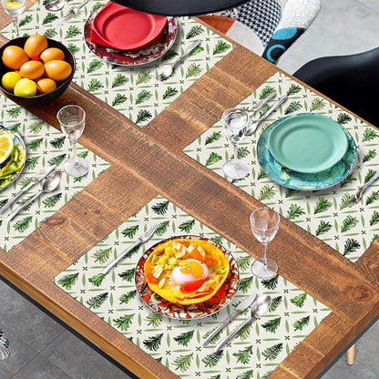Four pine tree placemats arranged in an X layout, sage green print on light fabric.