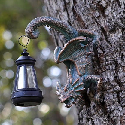 Dragon tree hugging wall decor with black solar lantern hanging from a dark bronze form