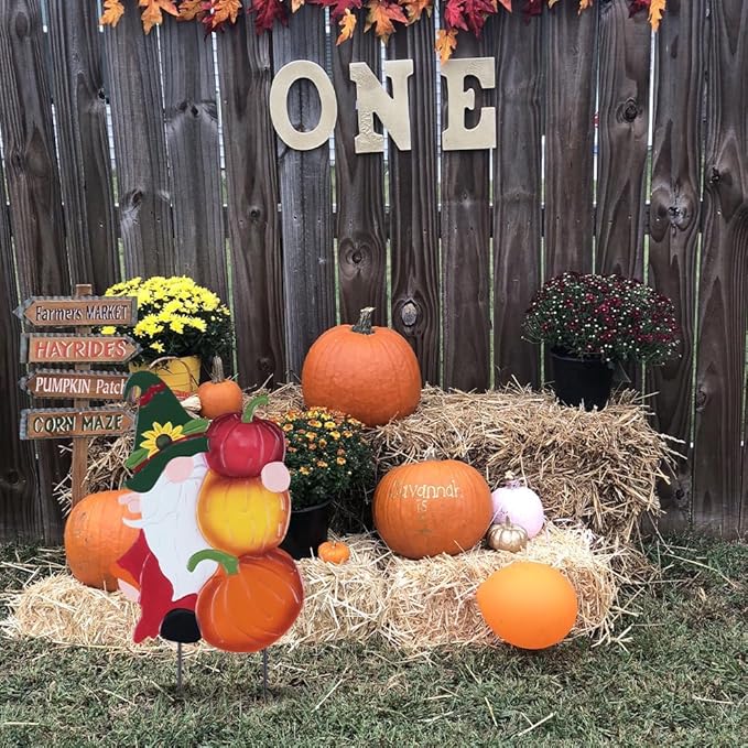 Metal garden gnome stake topper with orange, red and yellow pumpkins, green hat and white beard