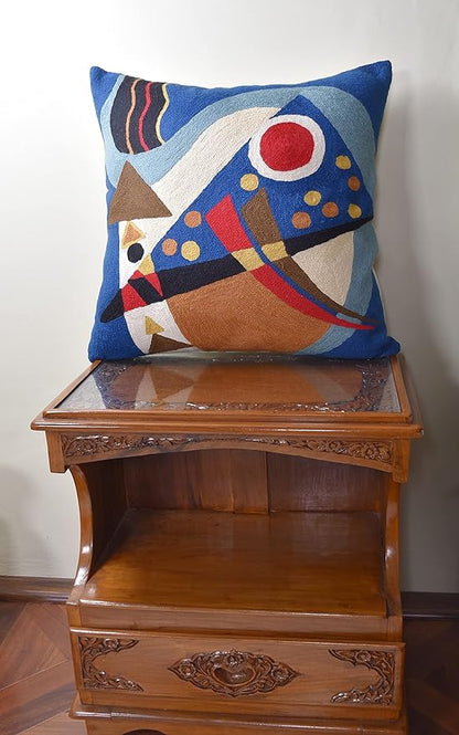 Blue abstract geometric pillow cover with red ring, cream shapes, and yellow dots