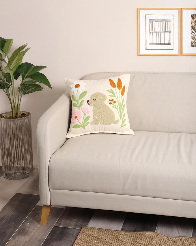 Dog and flower embroidered pillow cover on a white sofa, square cream design