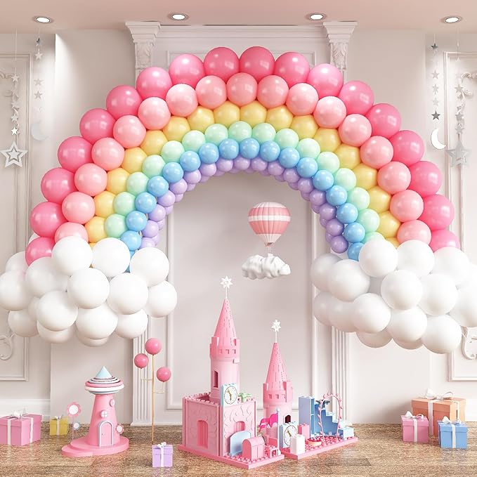 Rainbow balloon arch with pink, yellow, blue, and purple balloons and white cloud clusters