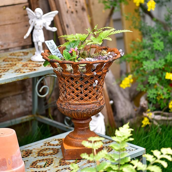 Cast-iron openwork urn planter with lattice sides and pedestal base, dark rust finish