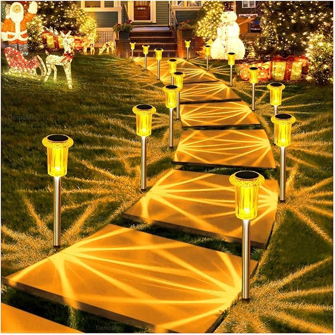 Outdoor solar lantern stake lights illuminating a walkway with warm amber light