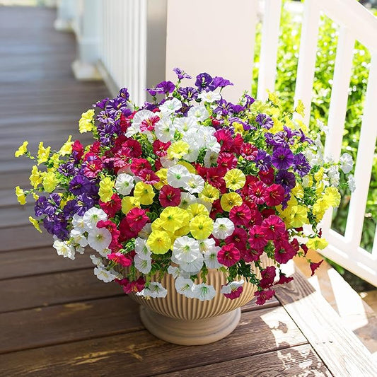 Faux morning glory arrangement in white ribbed pot, mixed purple red yellow and white blooms