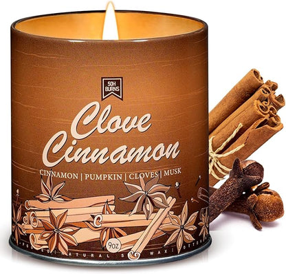 Clove Cinnamon scented soy wax candle in brown tin, lit wick and cinnamon sticks
