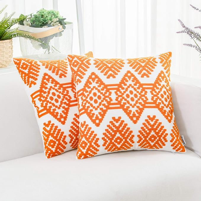 Orange embroidered throw pillow cover with white geometric diamond pattern