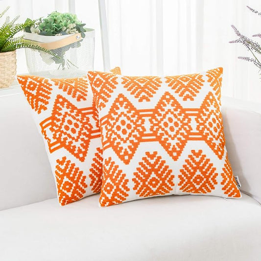 Orange embroidered throw pillow cover with white geometric diamond pattern