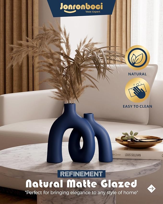 Matte navy matte-glazed ceramic hug vase with conjoined curved forms.