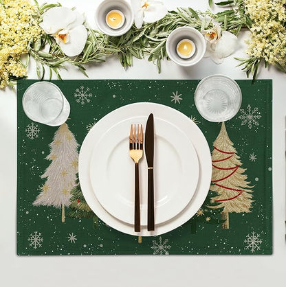 Green Christmas placemat with pine tree and snowflake pattern under plate and cutlery