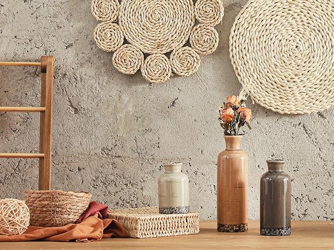 Three terracotta and gray ceramic vases with textured speckled bottoms