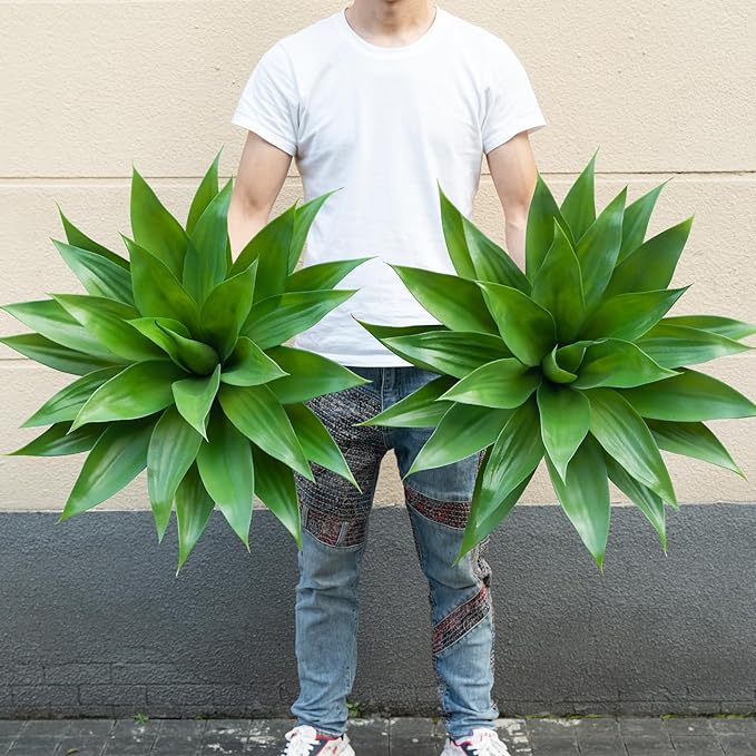Pair of green faux agave plants with spiky leaves on tan stems in pots