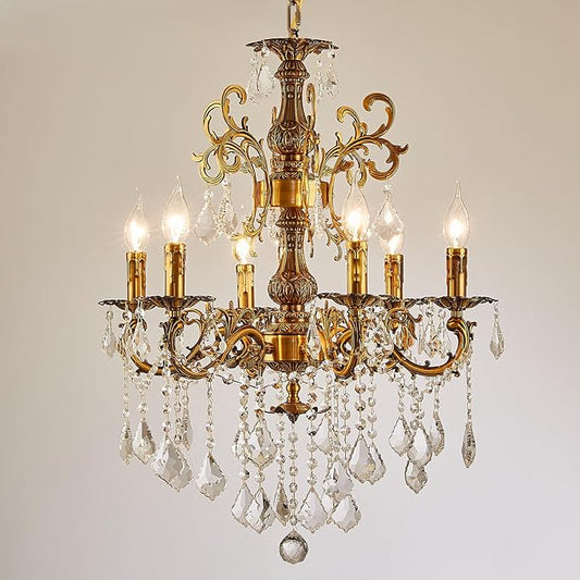 Antique gold crystal chandelier with six candle-style bulbs and hanging crystal prisms