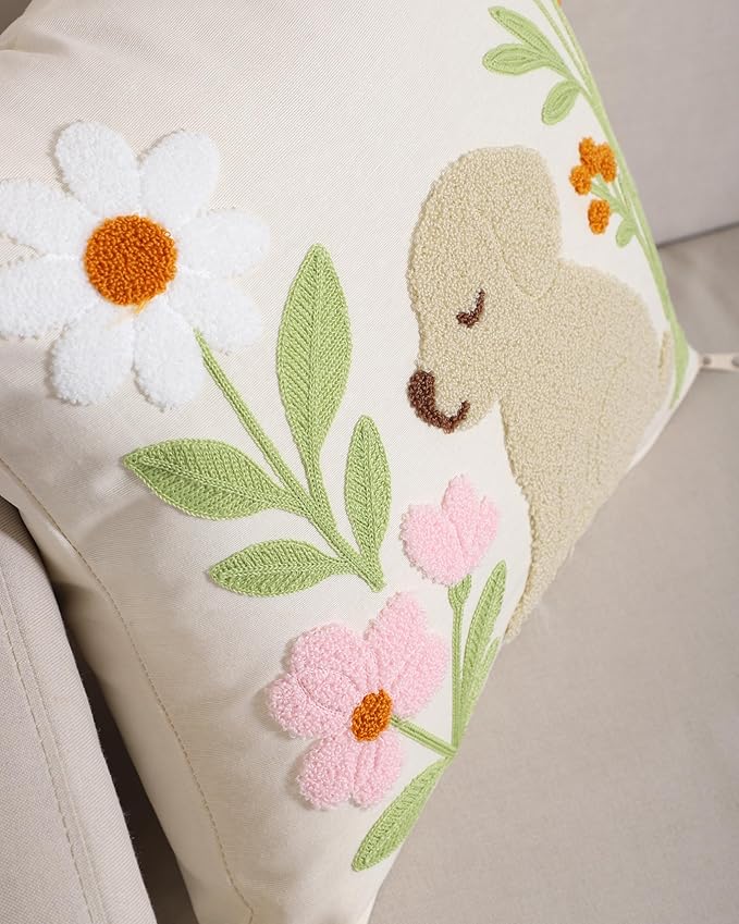 Side close-up of embroidered dog and flowers on light cream textured pillow cover