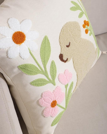 Side close-up of embroidered dog and flowers on light cream textured pillow cover